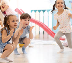 kids preschool kindergarten having fun and happy jumping in playroom