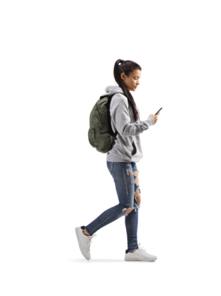 Full length profile shot of a female student with a backpack walking and looking into a mobile phone isolated on white background